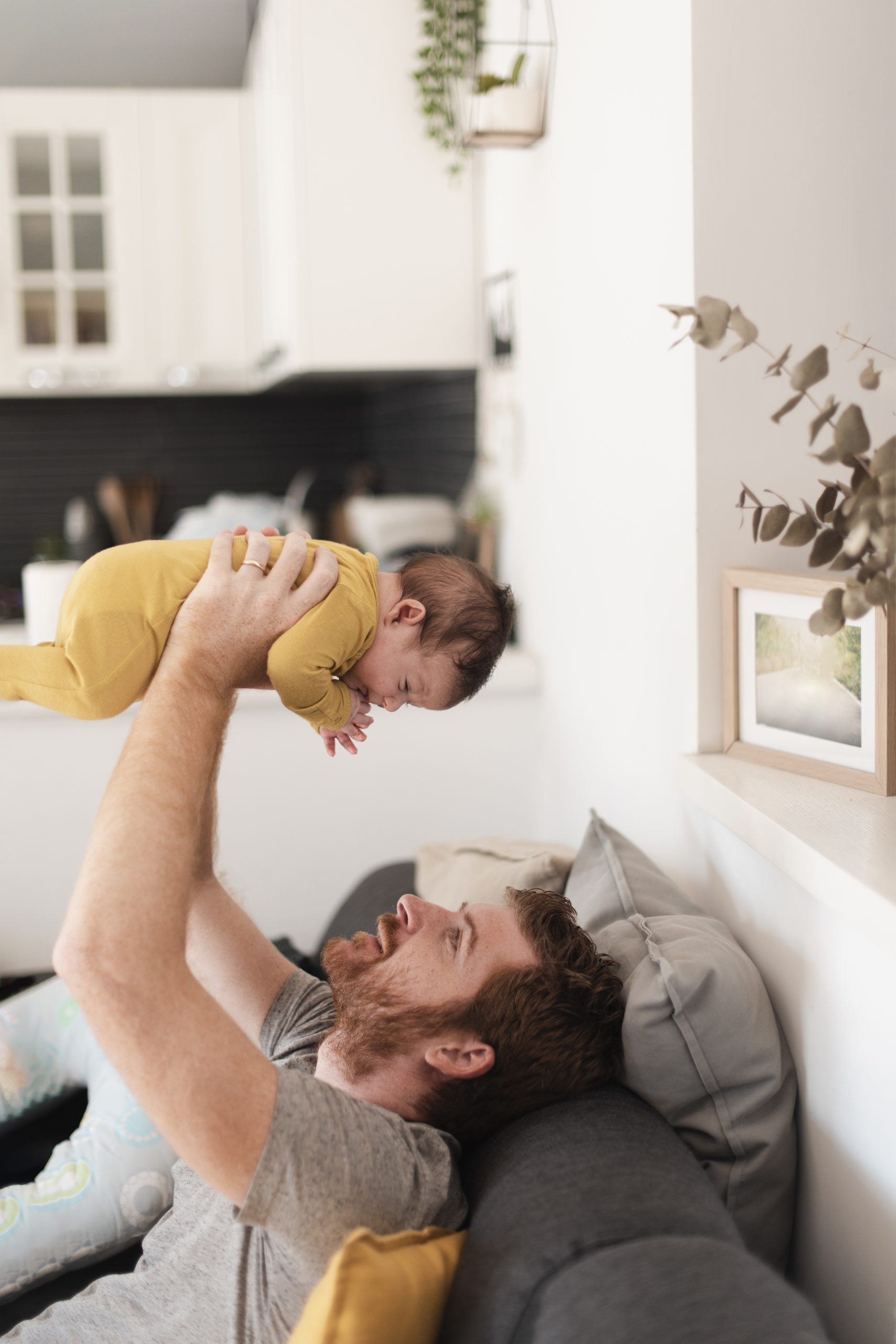 medium-shot-dad-holding-up-baby